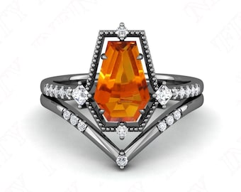 May include: A black gold engagement ring set with a large orange gemstone in a geometric setting. The ring has a delicate band with small diamonds.