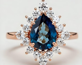 Anello a forma di pera con topazio blu di Londra: argento sterling placcato oro rosa e contorno di moissanite.