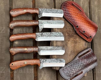 May include: Five fixed-blade knives with dark brown wooden handles and silver metal rivets, featuring hammered steel blades with straight edges. Two brown leather sheaths with a basket-weave pattern are positioned to the right of the knives.