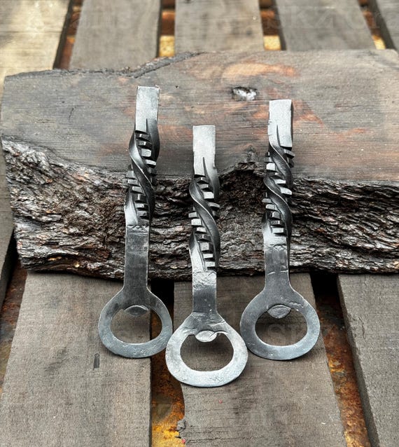 Hand-forged at an actual anvil, this Viking-aesthetic heavy-duty bottle opener set is the kind of groomsmen gift that gets passed down, not tossed in a drawer.