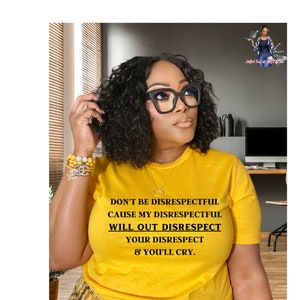May include: A woman wearing a yellow t-shirt with the text "DON'T BE DISRESPECTFUL CAUSE MY DISRESPECTFUL WILL OUT DISRESPECT YOUR DISRESPECT & YOU'LL CRY."