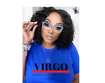 May include: A woman wearing cat-eye glasses with colorful accents. She is wearing a blue t-shirt with the word "VIRGO" in black letters, underlined with a red line, and the words "Hard Worker, Reliable, Creative & Kind" below.