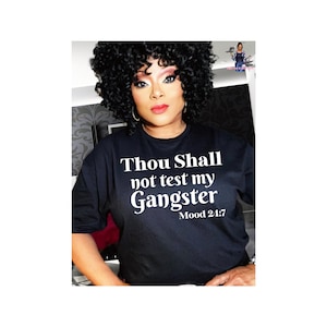 May include: Black t-shirt with white text that reads "Thou Shall not test my Gangster Mood 24:7".