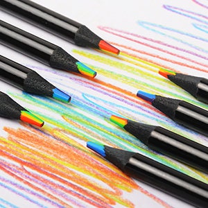 May include: Set of rainbow colored pencils with black barrels. The pencils are arranged in a staggered pattern on a white surface.