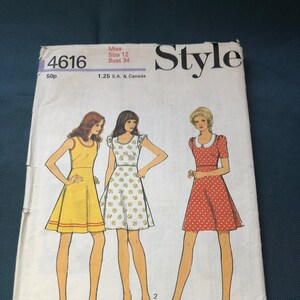 May include: A vintage sewing pattern for a dress, featuring three different styles. The pattern number is 4616, the size is 12, and the bust measurement is 34 inches. The pattern is for a miss and costs 50p. The dress styles are a yellow dress with a red trim, a white dress with a floral print, and a red dress with white polka dots.