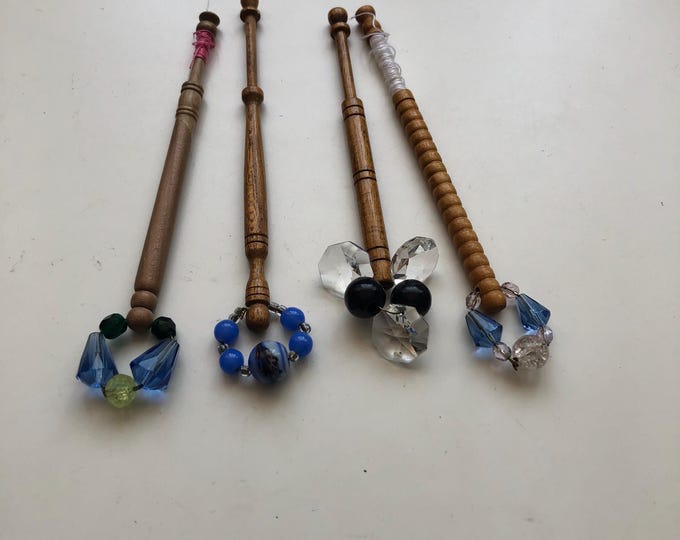 4 wooden lace bobbins with spangles