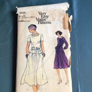 May include: Vintage sewing pattern for a dress, featuring two women wearing different styles of dresses. The pattern is labelled "Very Easy Vogue Patterns" and includes the size and bust measurements. The pattern is in a white envelope with a light blue background.