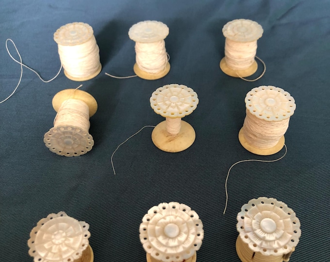 Mother of pearl thread spools, thread waxer, tape measure and pin cushion