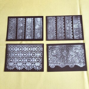 May include: Four rectangular cards featuring detailed white lace patterns set against a dark brown backdrop. The lace designs are diverse, displaying various styles and textures. The cards are arranged in a 2x2 grid.
