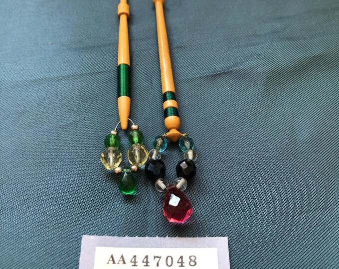 Lacemaking bobbins with green wire decoration