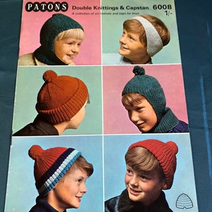 May include: A vintage knitting pattern booklet from Patons featuring six different designs for boys' hats and caps. The booklet cover features photos of boys wearing the hats and caps, with the title "Double Knittings & Capstan 6008 1/-."