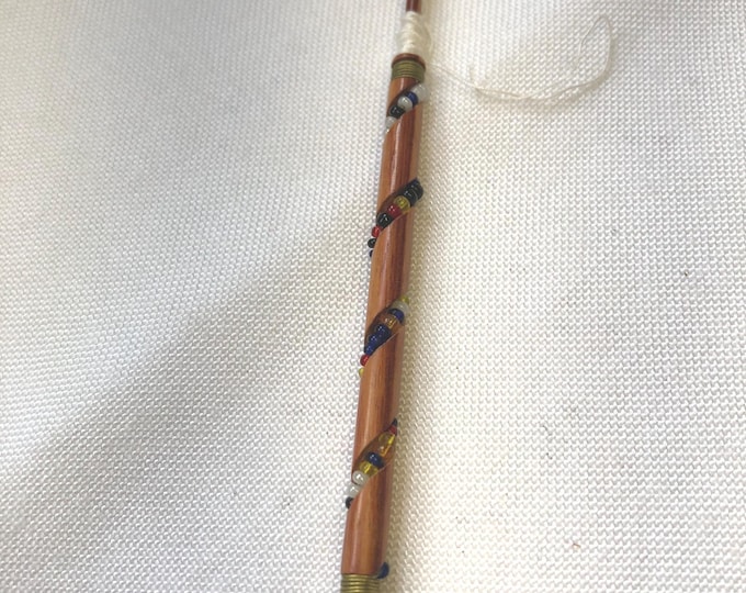Wooden vintage lacemaking bobbin with beading.