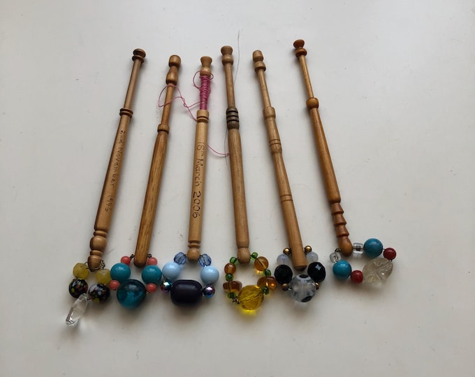 6 wooden lace bobbins with spangles