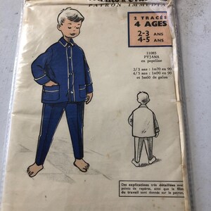 May include: A vintage sewing pattern for a child's pajama set. The pattern is for sizes 2-3 and 4-5 years old. The pattern is for a pajama set made of poplin fabric. The pattern includes instructions for making the pajama set. The pattern is in French.
