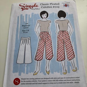 May include: A sewing pattern for Classic Pleated Culottes #019 by Simple Sew. The pattern features a drawing of the culottes in red and white, with a beginner level and UK sizes 8-20. The Simple Sew logo is visible.