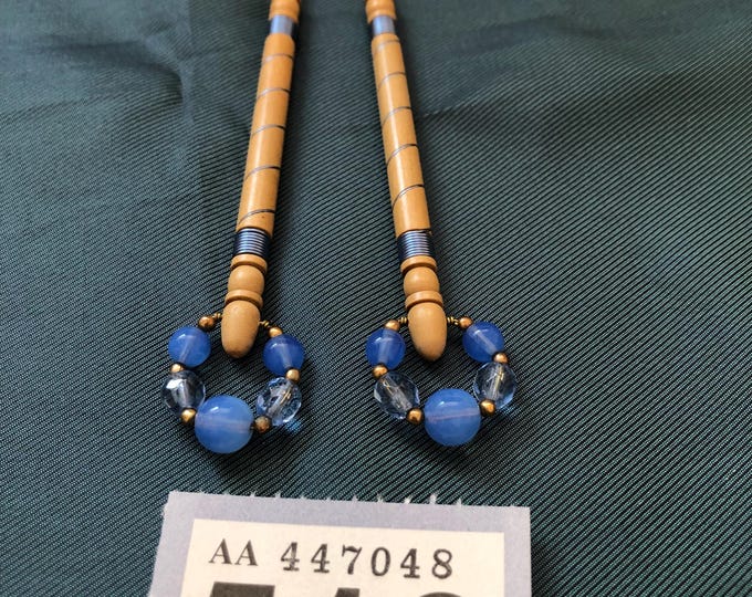 Lacemaking bobbins with blue wire decoration