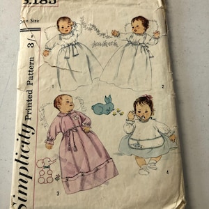 May include: Vintage Simplicity sewing pattern number 5.185 for a baby's dress and gown. The pattern includes four different styles, with illustrations of each garment.