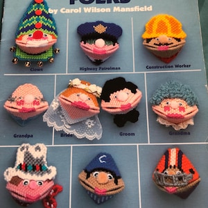 May include: A plastic canvas craft pattern book featuring 10 different characters, including a clown, highway patrolman, construction worker, grandpa, bride, groom, grandma, cowboy, baseball player, and football player. The book is titled "SQUEEZUM FOLKS" by Carol Wilson Mansfield.
