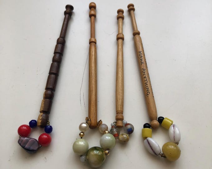 4 wooden lace bobbins with spangles