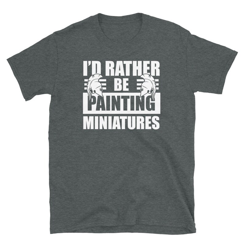 May include: A dark heather grey t-shirt with the text "I'd rather be painting miniatures" in white. The text is framed by two white Roman helmet illustrations.