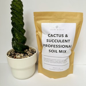 May include: A brown paper bag with a white label that reads "Cactus & Succulent Professional Soil Mix". The label lists the ingredients: pumice, worm castings, fine bark, feather meal, recycled products, and hydrolyzed feather meal. The bag is labeled "Weight 2 lbs" and "Hand Mixed in Small Batches". A green cactus plant is in a white pot.