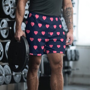 May include: Navy blue athletic shorts with a pink heart pattern.