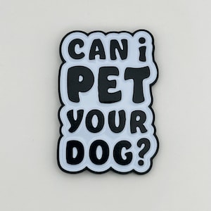 May include: Black and white enamel pin with the text "Can I pet your dog?" in a playful, rounded font.