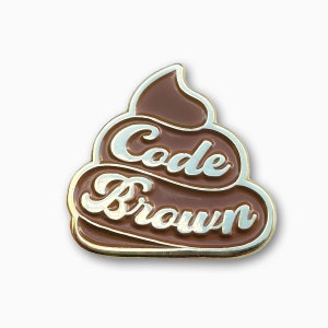 May include: A gold-colored pin shaped like a pile of poop with the words "Code Brown" written in white on it.
