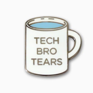 May include: White enamel pin shaped like a coffee mug with the text "Tech Bro Tears" in black lettering.