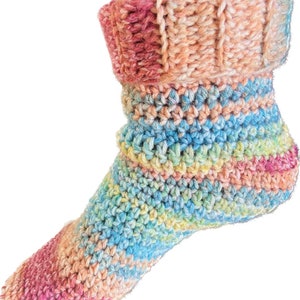 May include: A pair of colourful crochet slipper socks with a rainbow pattern. The socks have a folded cuff and are made with a soft yarn.