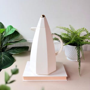 May include: A rustic wooden sign with the text "Welcome to our home" in white lettering. The sign features a distressed finish and a simple, inviting design, perfect for a front porch or entryway.