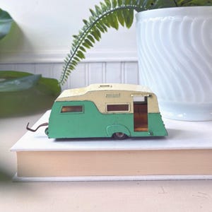 May include: A set of three ceramic mugs with a speckled, matte finish. Each mug features a different color: light blue, cream, and gray. The mugs have a simple, modern design and a comfortable handle.