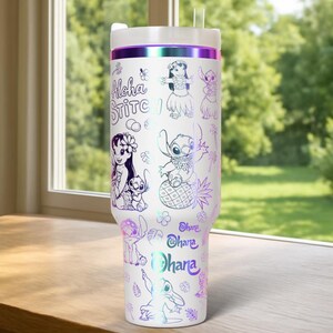 May include: White insulated travel mug with a lid and straw. The mug has a design featuring the words "Aloha Stitch" and cartoon characters in a holographic, iridescent finish. The design includes images of Stitch and Lilo.