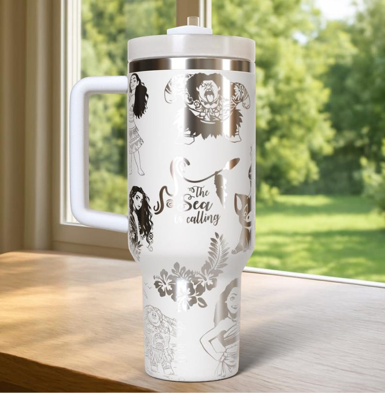 May include: White insulated tumbler with a handle, featuring silver illustrations of characters and floral designs. The text "The Sea is Calling" is also displayed. The tumbler has a white lid and handle.