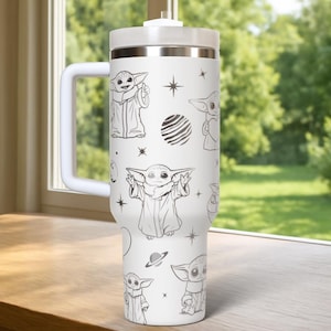 May include: White insulated tumbler with a handle, featuring a repeating pattern of a cartoon character in various poses, along with stars and planets. The tumbler has a white lid and handle, and a silver band near the top.