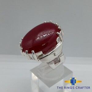A statement silver ring of deep red cabochon Ruby. It is widely known as Anari Yaqoot Ring, Pomegranate Ruby gemstone Ring, Handmade 925 Silver Ring, Big Size Red Ruby ring. It is a perfect gift for men for birthday, anniversary and valentine day.