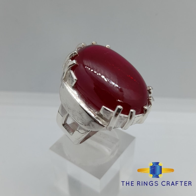 A statement silver ring of Deep Red Cabochon Ruby. It is widely known as Anari Yaqoot Ring, Pomegranate Ruby Ring, Anari Yakoot 925 Silver Ring, Big Size Red Ruby ring. It is a perfect gift for men for birthday, anniversary and valentine day.