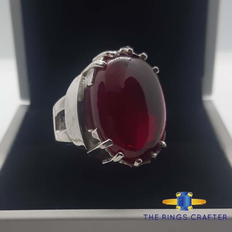 A statement silver ring of deep red cabochon Ruby. It is widely known as Anari Yaqoot Ring, Pomegranate Ruby gemstone Ring, Handmade 925 Silver Ring, Big Size Red Ruby ring. It is a perfect gift for men for birthday, anniversary and valentine day.