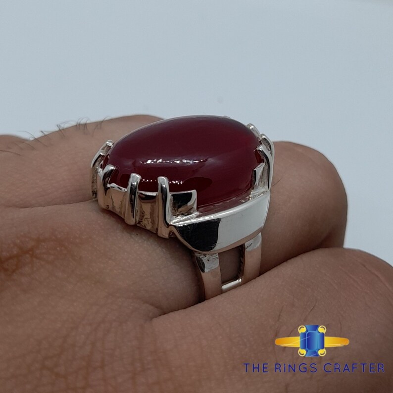A statement silver ring of deep red cabochon Ruby. It is widely known as Anari Yaqoot Ring, Pomegranate Ruby gemstone Ring, Handmade 925 Silver Ring, Big Size Red Ruby ring. It is a perfect gift for men for birthday, anniversary and valentine day.