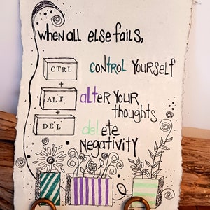 May include: A rectangular piece of textured paper featuring black ink illustrations and text. The text reads: when all else fails, control yourself, alter your thoughts, delete negativity. Three keyboard keys labeled CTRL, ALT, and DEL are drawn.