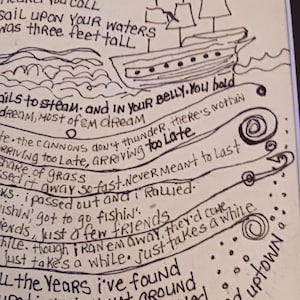 May include: A black ink drawing on a light background featuring a sailing ship and handwritten lyrics. The text includes phrases like Mother Ocean, heard you call, sail upon your waters, and was three feet tall, alongside swirling line art designs.
