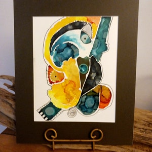 May include: Abstract watercolor painting in a dark brown frame. The painting features a yellow, orange, blue, and black color scheme. The painting is on a white background.