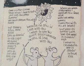 May include: A hand-drawn illustration on textured paper featuring two mice dancing under a full moon and a sunflower. The artwork includes handwritten lyrics: Come a little closer hear what I have to say, because I'm still in love with you, on this harvest moon.