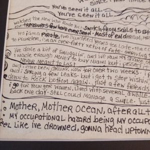 May include: A white paper print featuring black hand-lettered lyrics from the song A Pirate Looks at Forty. The text includes lines such as Mother Mother Ocean, I am a pirate, and I've done a bit of smugglin', arranged with wavy line illustrations.