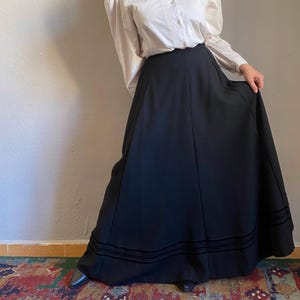 May include: A set of three ceramic mugs with a speckled, matte finish in cream, light grey, and dark grey. Each mug has a simple, minimalist design and a rounded handle. The mugs are stacked on top of each other.