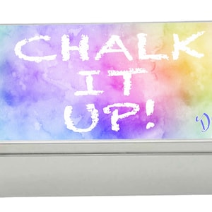 May include: A rectangular metal tin with a watercolour design in shades of purple, blue, green, yellow, and orange. The words "CHALK IT UP!" are written in white, with the name "Daisy" in blue. The tin has a silver finish.