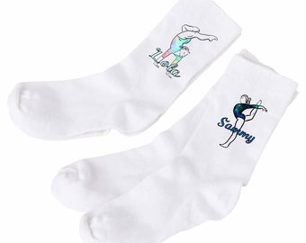 May include: Two pairs of white socks with a gymnast design and personalised names. The socks feature a colourful gymnast in a handstand pose with the name "Lola" on one pair and "Sammy" on the other.