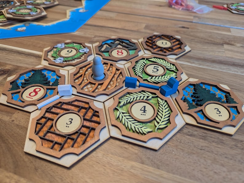 May include: A wooden game board with hexagonal tiles featuring numbers 3, 4, 5, 8, and 9. The tiles are arranged in a circular pattern with a small wooden figure in the center.