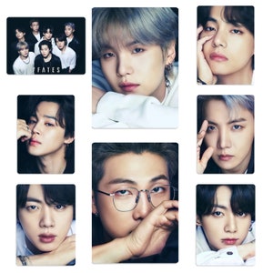 May include: A set of rectangular cards displaying portraits of seven people, and a group photo. The group photo has the text "7 FATES" in white. The portraits show diverse expressions and hairstyles, with an emphasis on facial features.