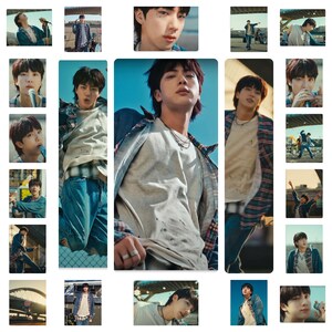 May include: A collage of images featuring a young man wearing a variety of casual outfits, including a white t-shirt, a plaid shirt, and a denim jacket. The images are set against a backdrop of a city street and a bridge.